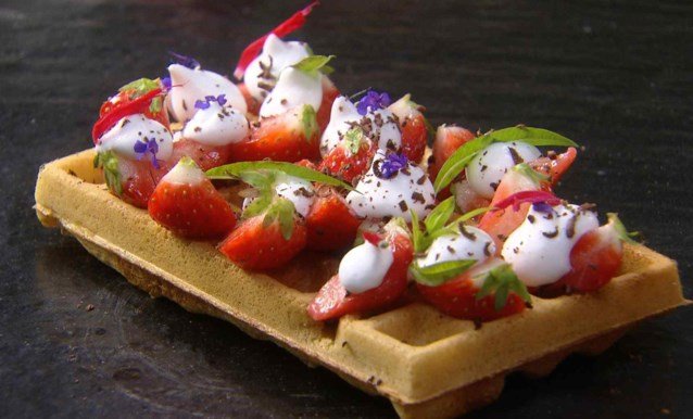 Brussels waffle with strawberries and whip cream.